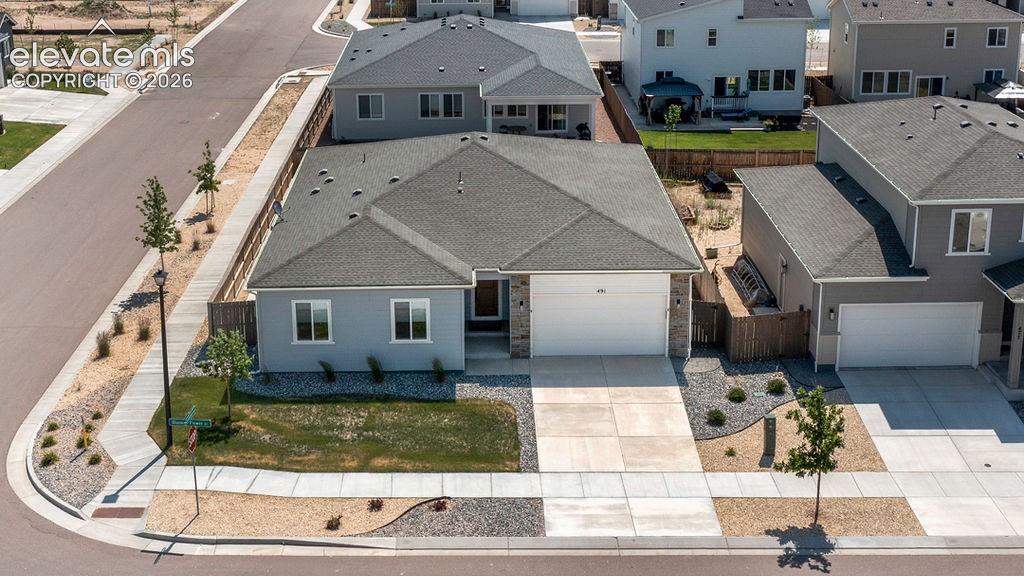 Image 45 of 47: Single-story residence featuring a light gray exterior with stone accents a
