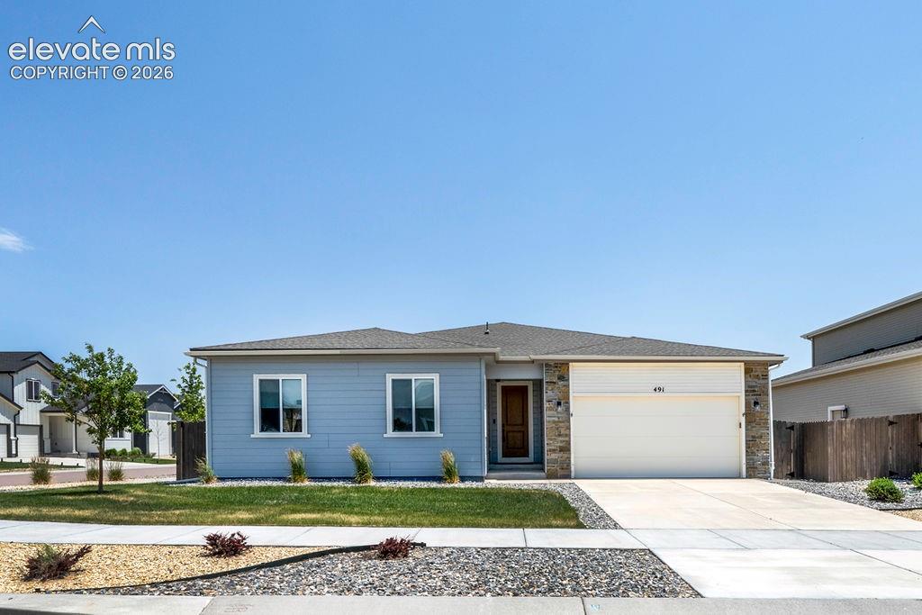 Image 46 of 47: Ranch-style residence featuring light blue siding with white trim accents a