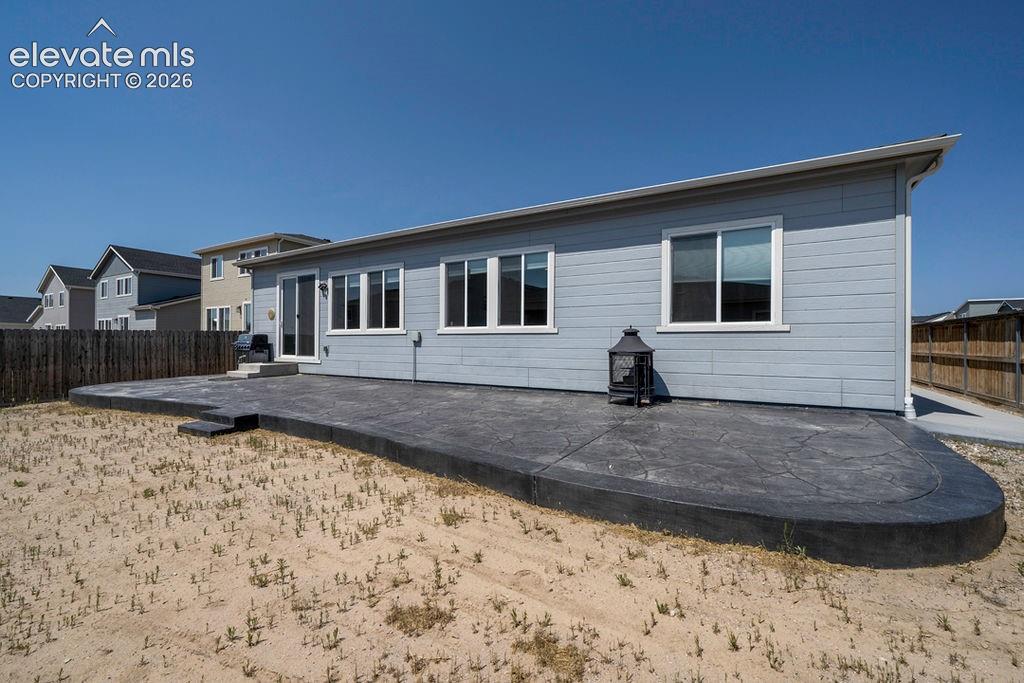 Image 5 of 47: Rear exterior featuring light blue siding with white trim