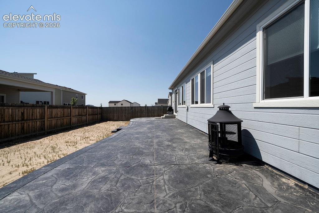 Image 6 of 47: Expansive stamped concrete patio with direct access to the home