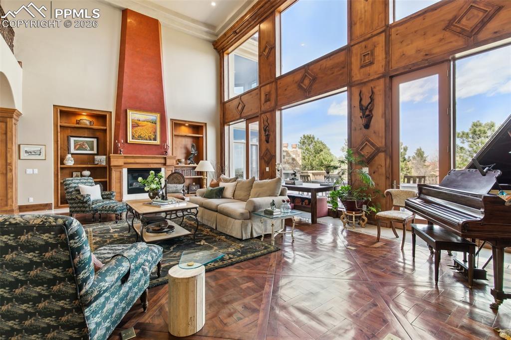 Image 8 of 50: Walnut paneling and a grand fireplace