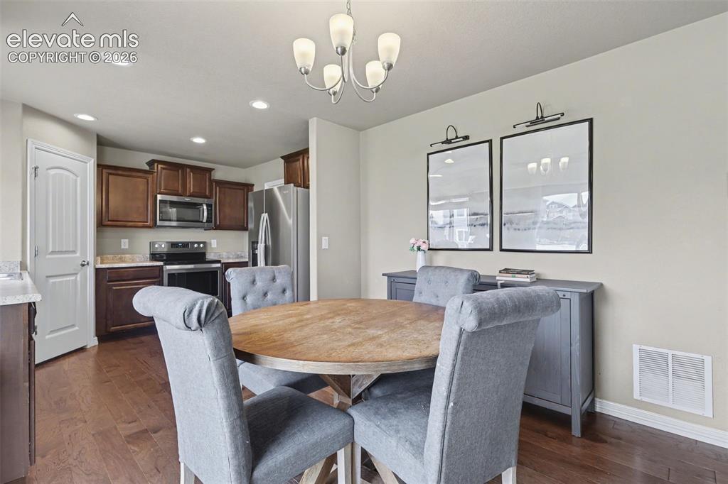 Image 12 of 40: Open-concept living space featuring wood-finish flooring, recessed lighting