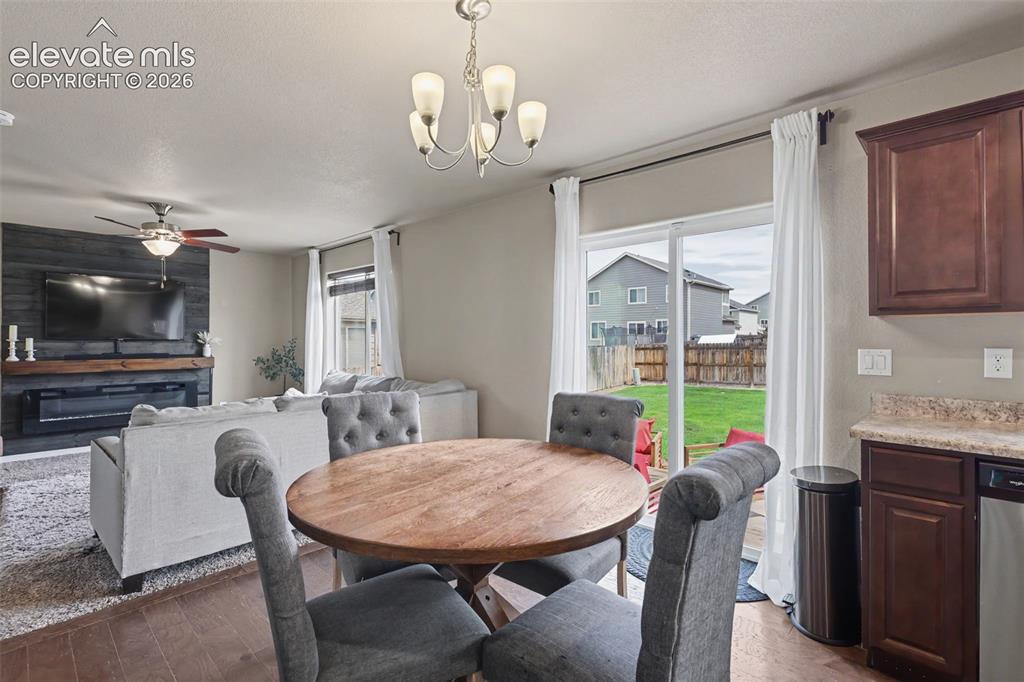 Image 13 of 40: Dining area featuring wood-finish flooring and a contemporary chandelier