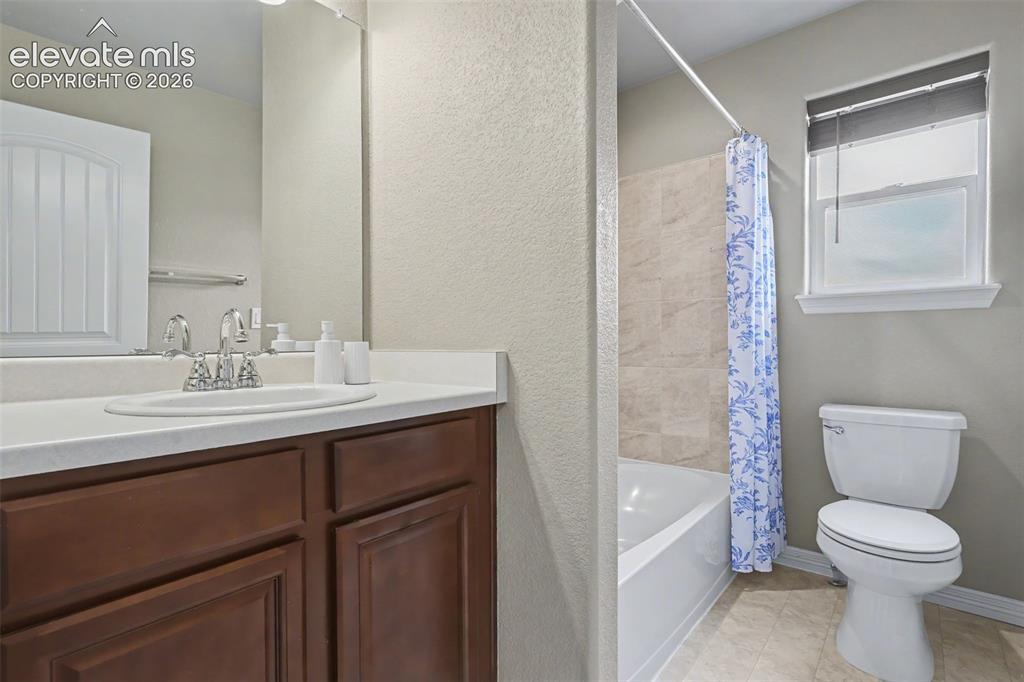 Image 26 of 40: Bathroom vanity with an integrated sink, polished chrome faucet, and wood-f