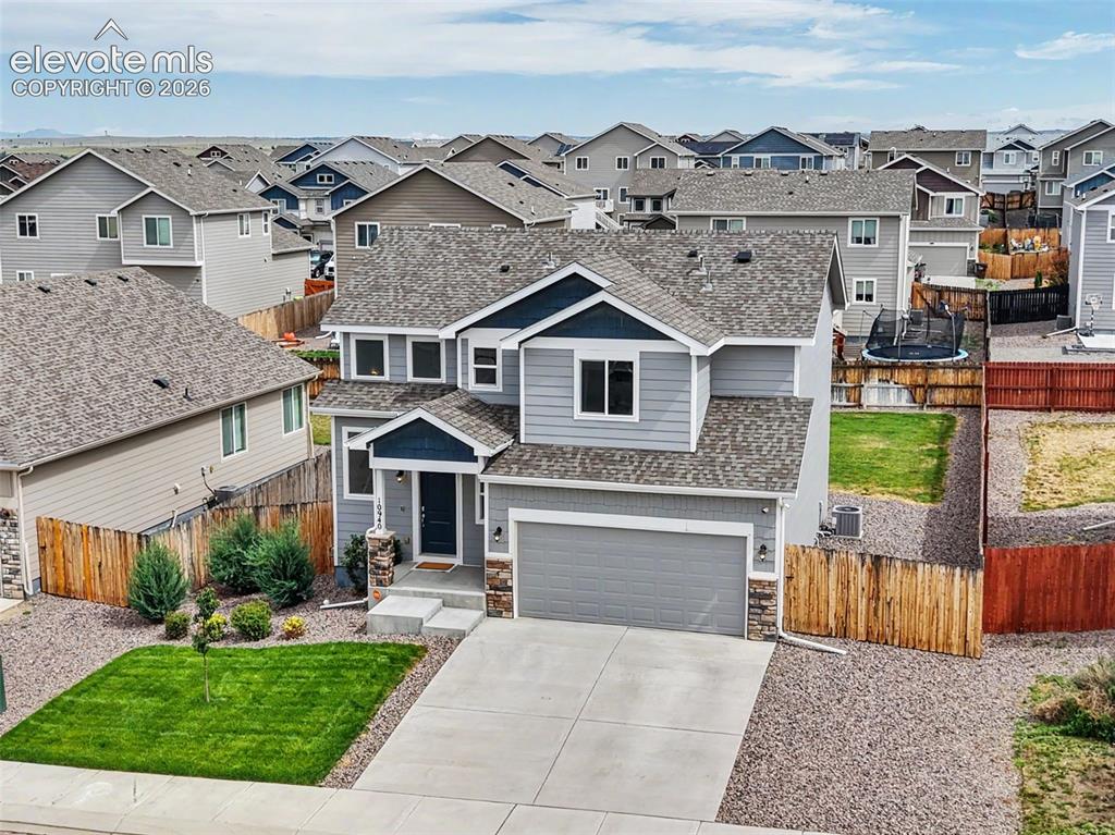 Image 39 of 40: Contemporary two-story residence featuring a gray and blue exterior with st