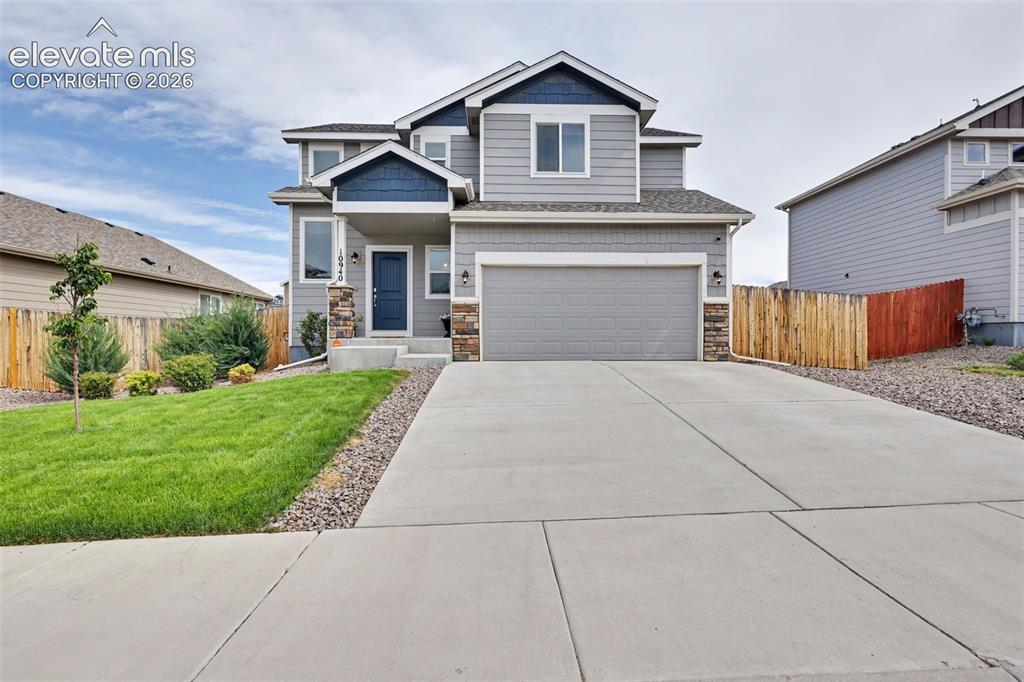 Image 6 of 40: Contemporary two-story residence featuring a gray and blue exterior with st