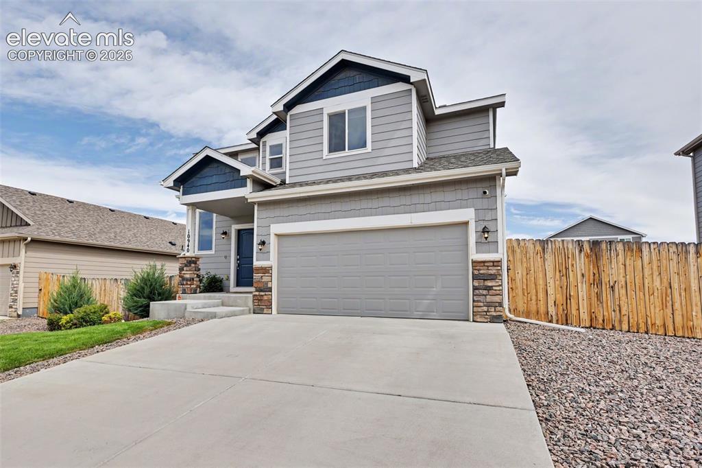 Image 7 of 40: Modern two-story residence featuring a covered entry, an attached garage, a