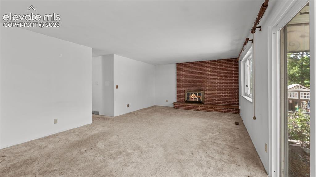 Image 4 of 36: Dining area opens to living room with gas fireplace