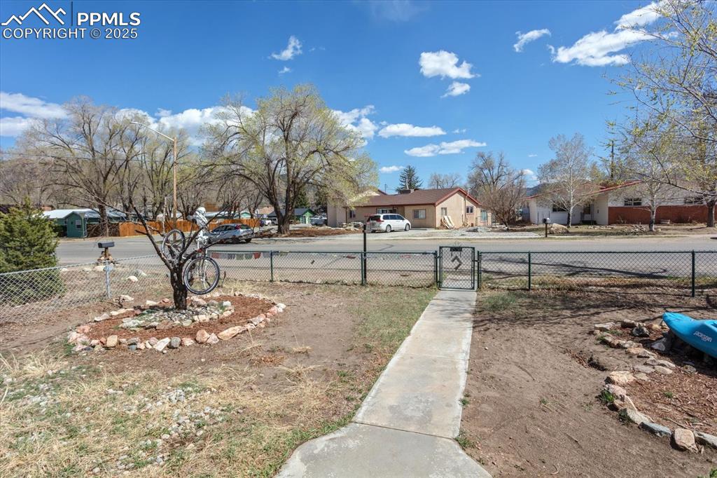 Image 19 of 26: View of yard featuring fence and a gate