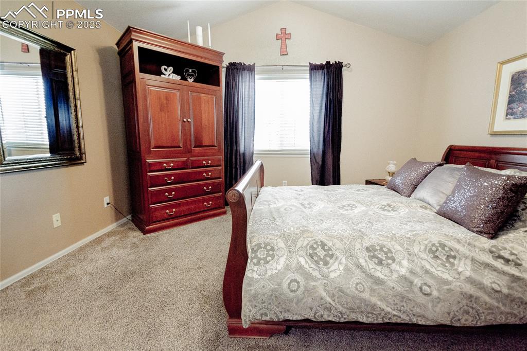 Image 15 of 33: Master bedroom featuring lofted ceiling