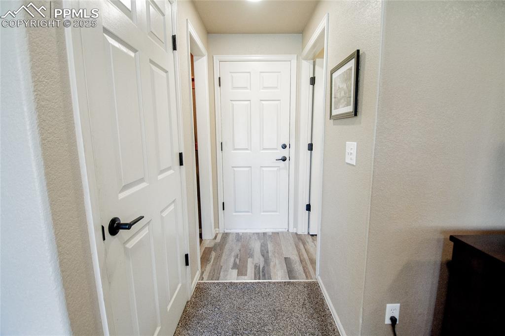 Image 21 of 33: Hallway from garage into lower level