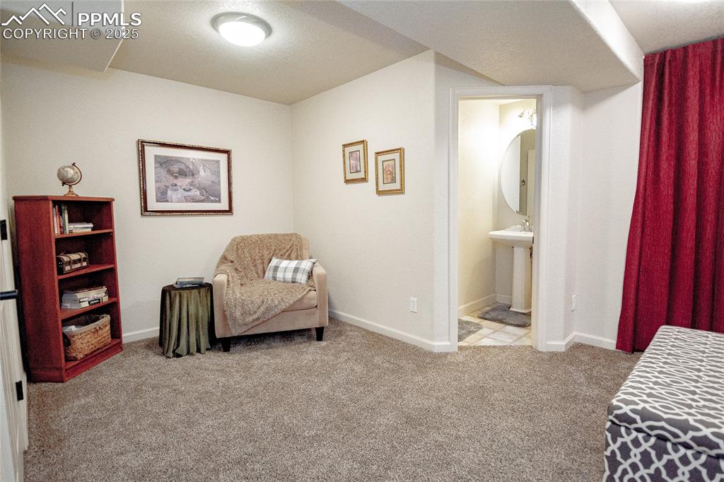 Image 28 of 33: Basement living/flex room into bathroom