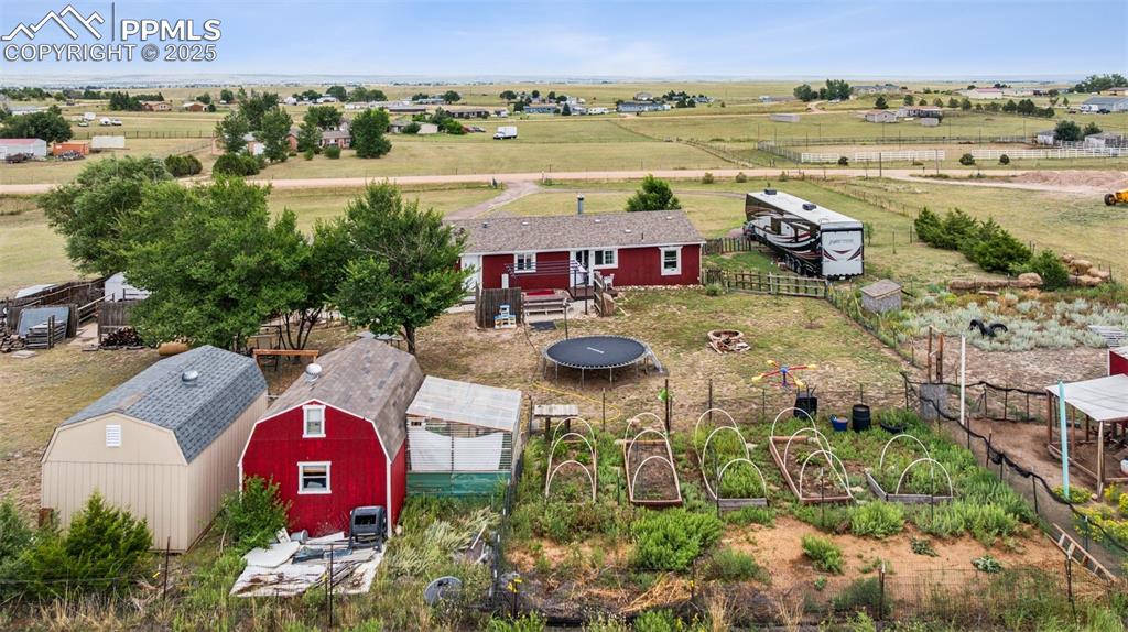 Image 5 of 33: Garden area.  Swing set and trampoline stay!