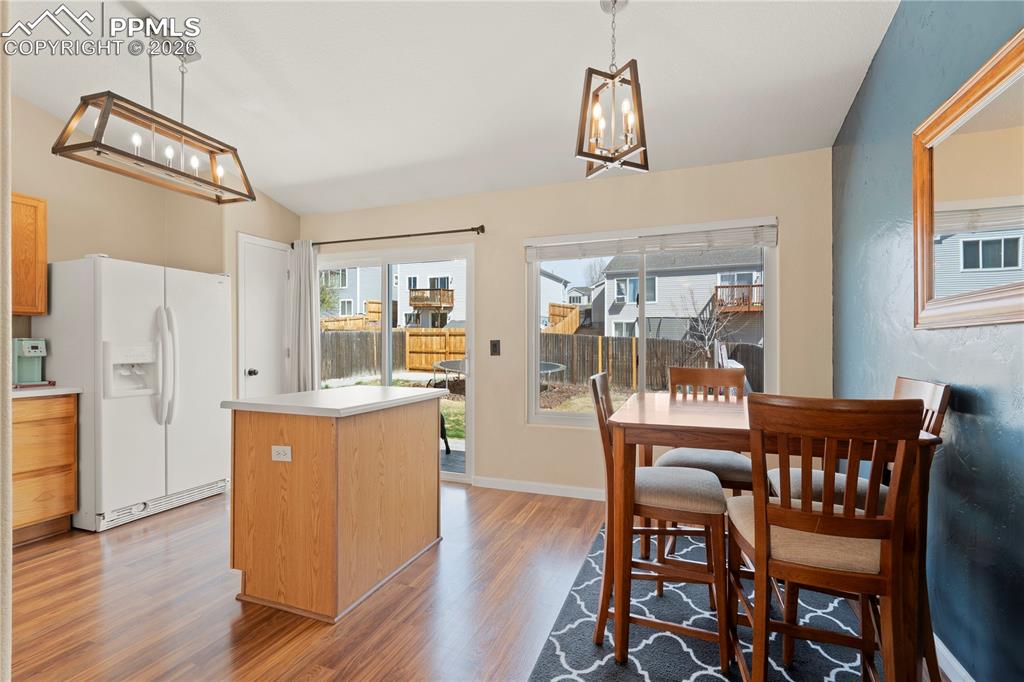 Image 11 of 27: Kitchen featuring a chandelier, white fridge with ice dispenser, a kitchen 