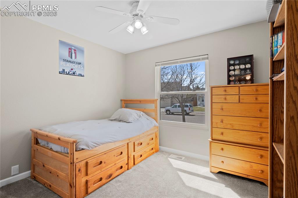 Image 26 of 27: Bedroom featuring a ceiling fan and light colored carpet