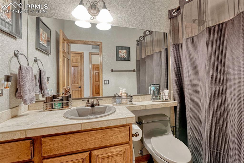 Image 21 of 45: Main level guest bathroom. with vanity, a tub/shower combo.