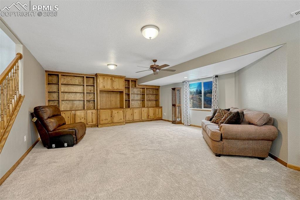 Image 25 of 45: Basement 2nd family/rec room  featuring ceiling fan, light colored carpet, 
