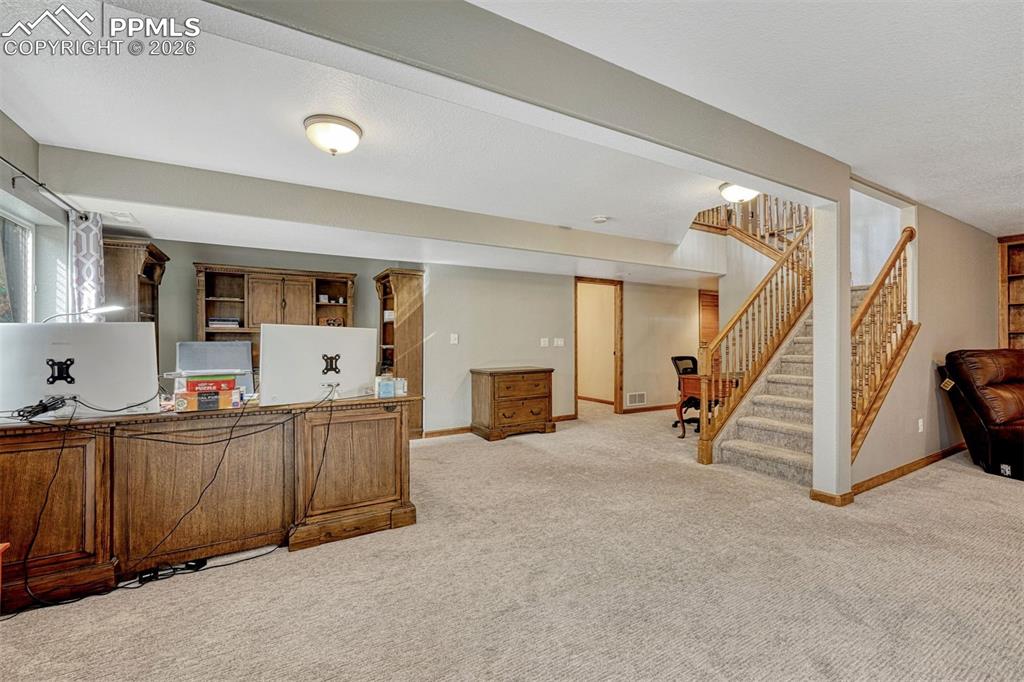 Image 29 of 45: Office space featuring light colored carpet and a textured ceiling
