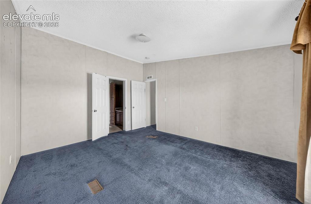 Image 16 of 41: Primary bedroom, adjoining bathroom, walk in closet