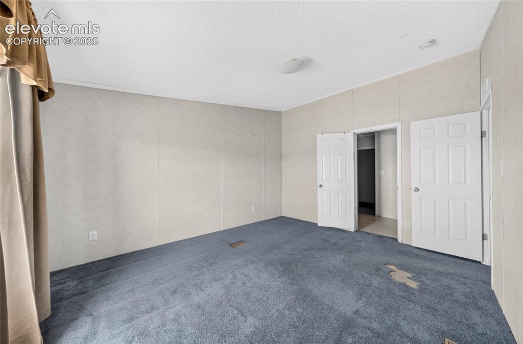 Image 17 of 41: Primary bedroom, adjoining bathroom, walk in closet