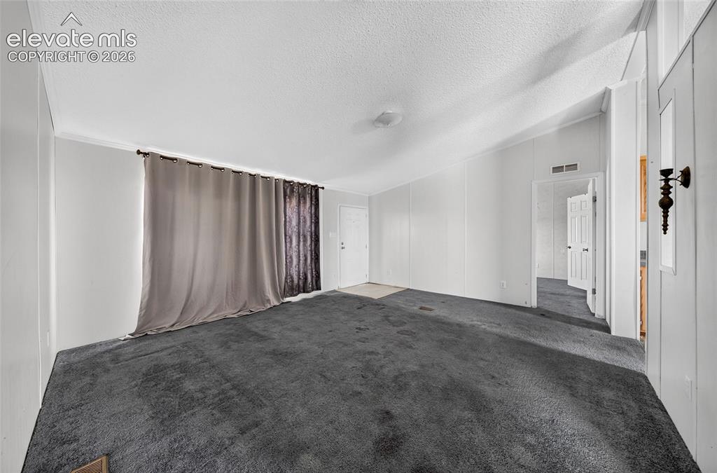 Image 4 of 41: Open-concept living area with carpeting