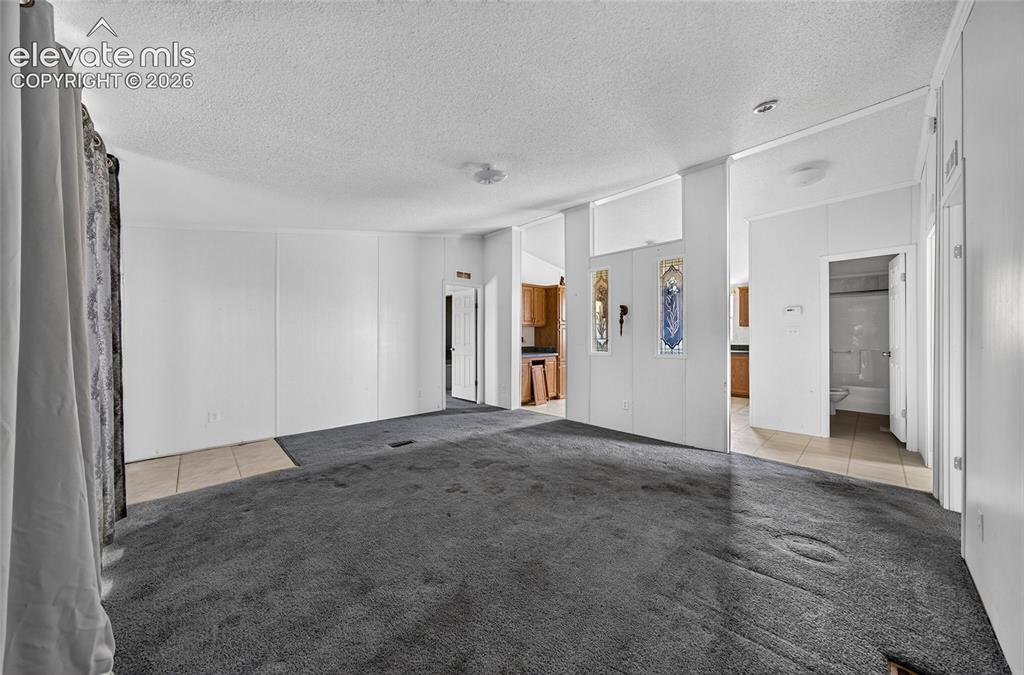 Image 5 of 41: Open-concept living area with carpeting
