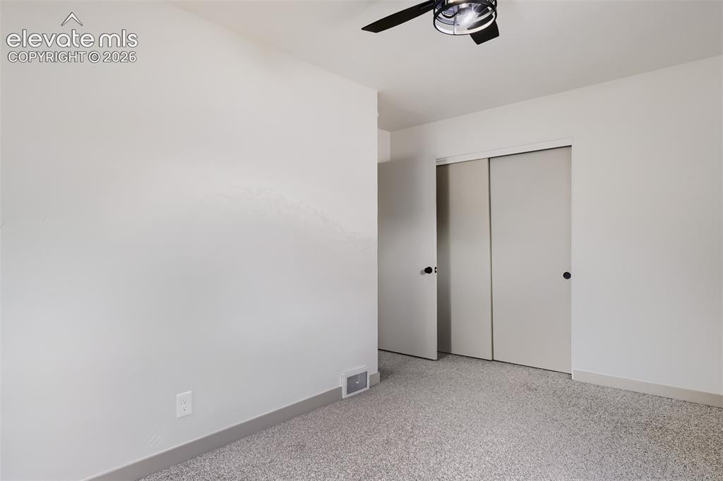 Image 20 of 41: Recessed lighting with a ceiling fan, light-toned carpet, and neutral wall 