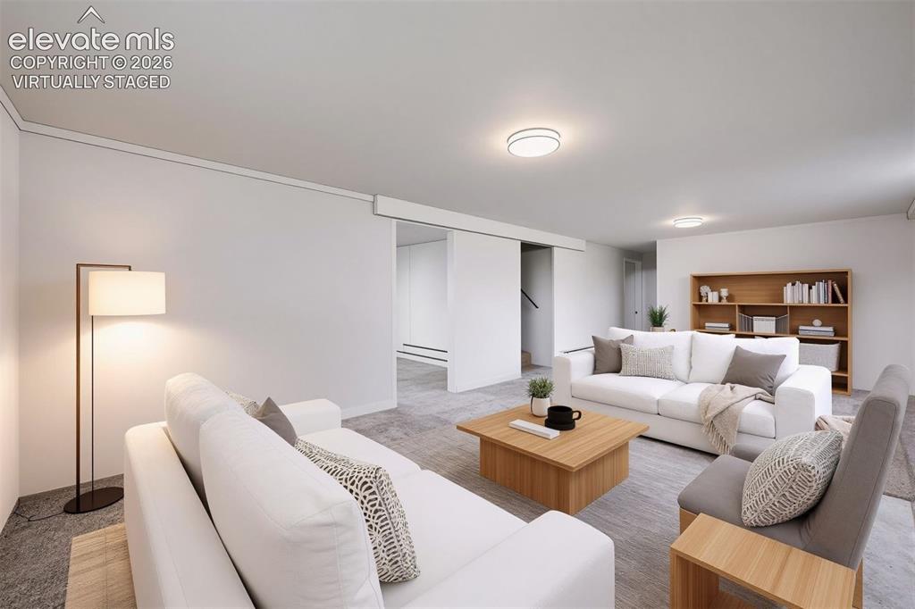 Image 23 of 41: Expansive living area with recessed lighting, light-toned walls, and wood-f