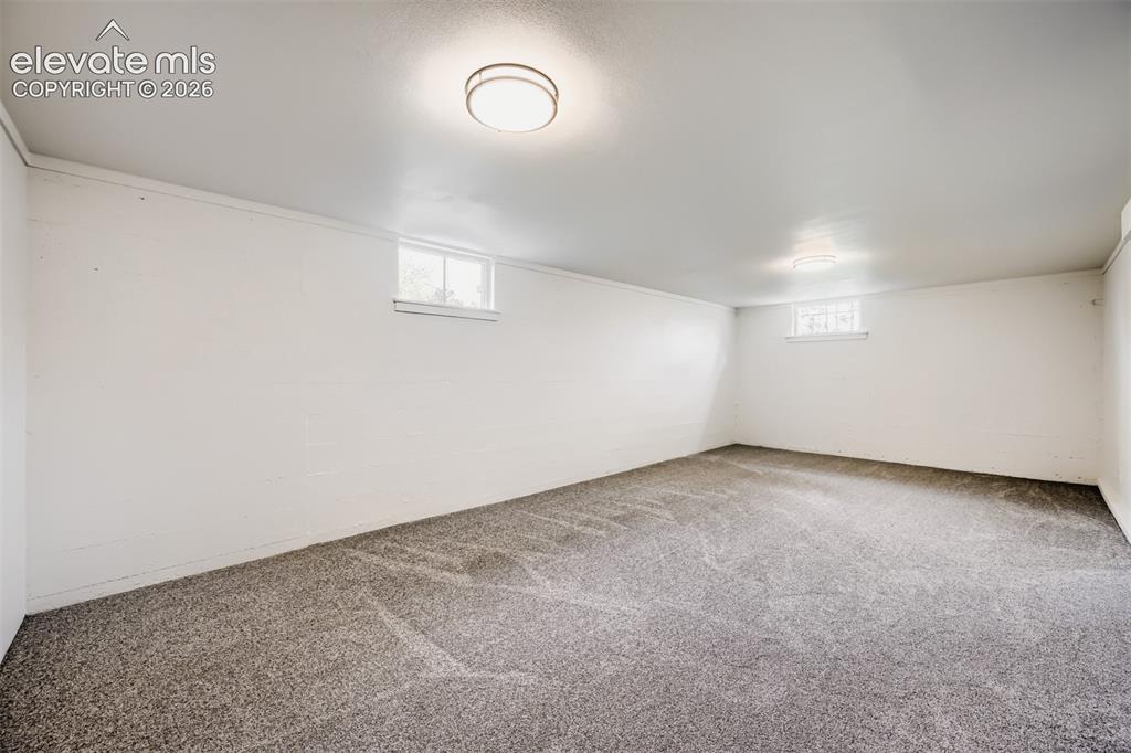 Image 26 of 41: Spacious room featuring neutral carpeting, white painted walls, and overhea