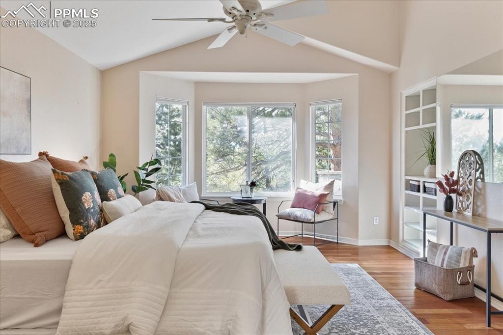 Image 14 of 46: Bedroom featuring wood finished floors, lofted ceiling, and ceiling fan
