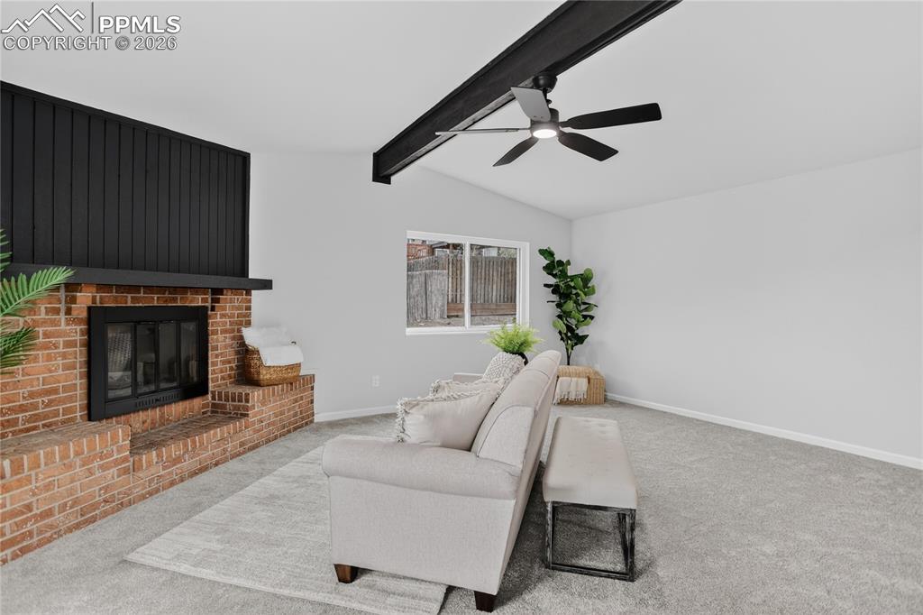 Image 10 of 24: Woodburning fireplace w/ brick surround