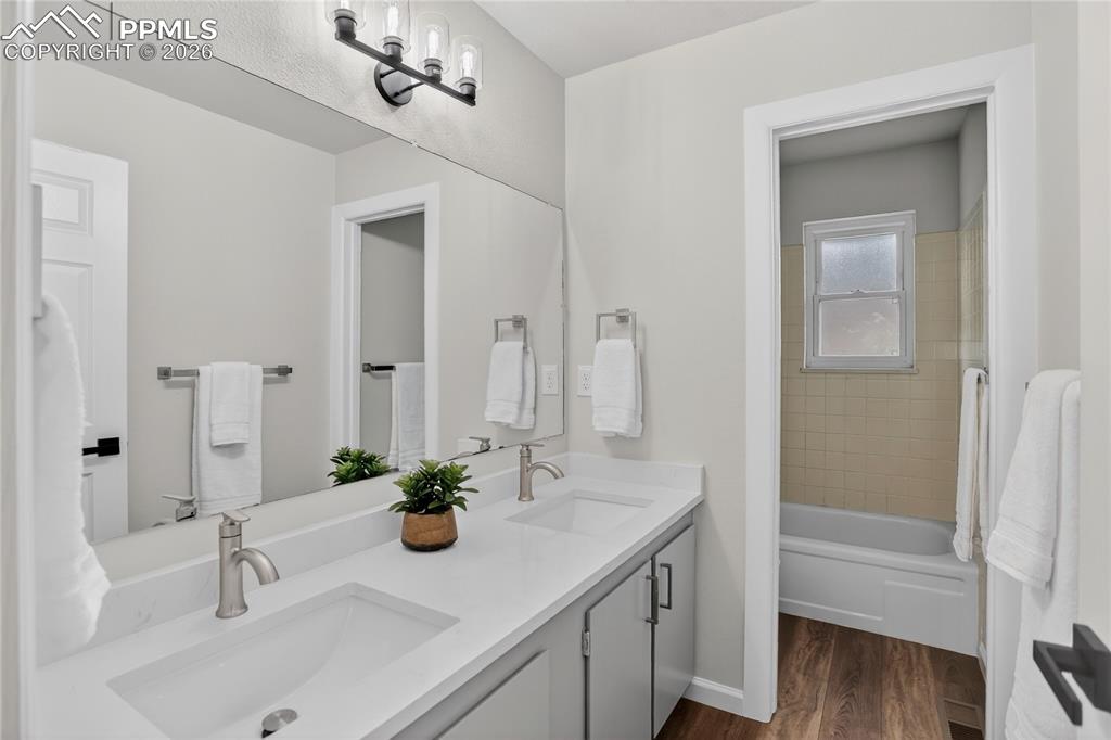 Image 19 of 24: Full guest bath w/ dual sink vanity
