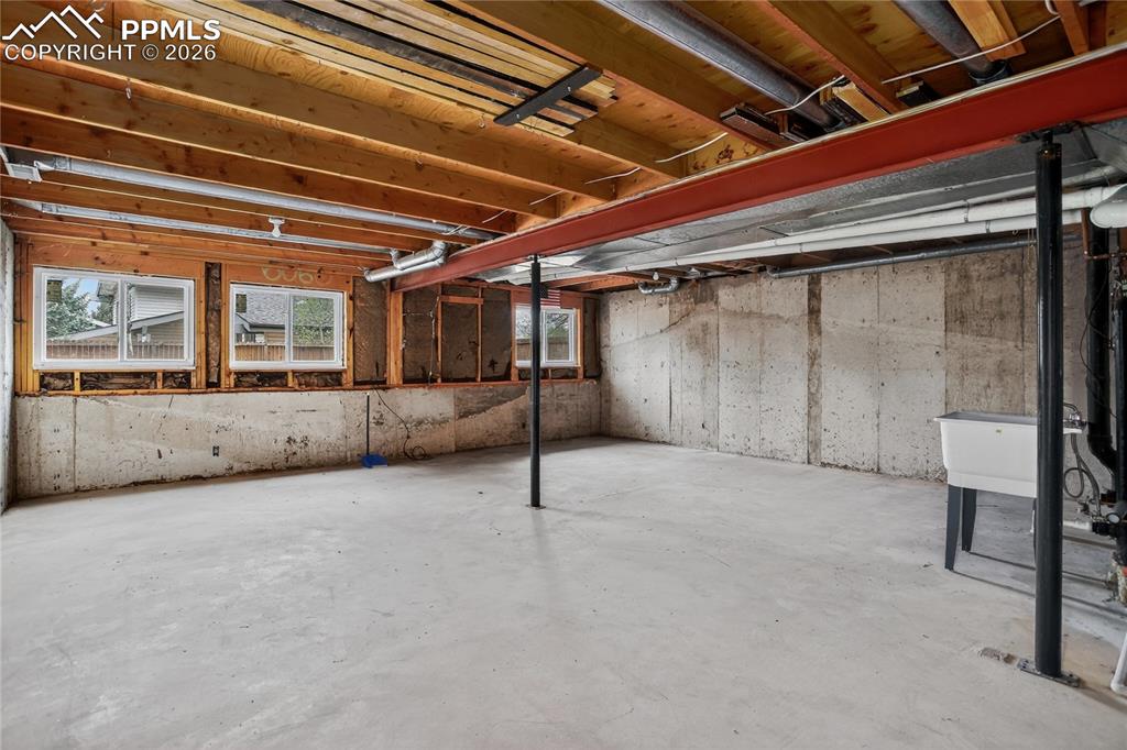 Image 20 of 24: Unfinished basement for future living space