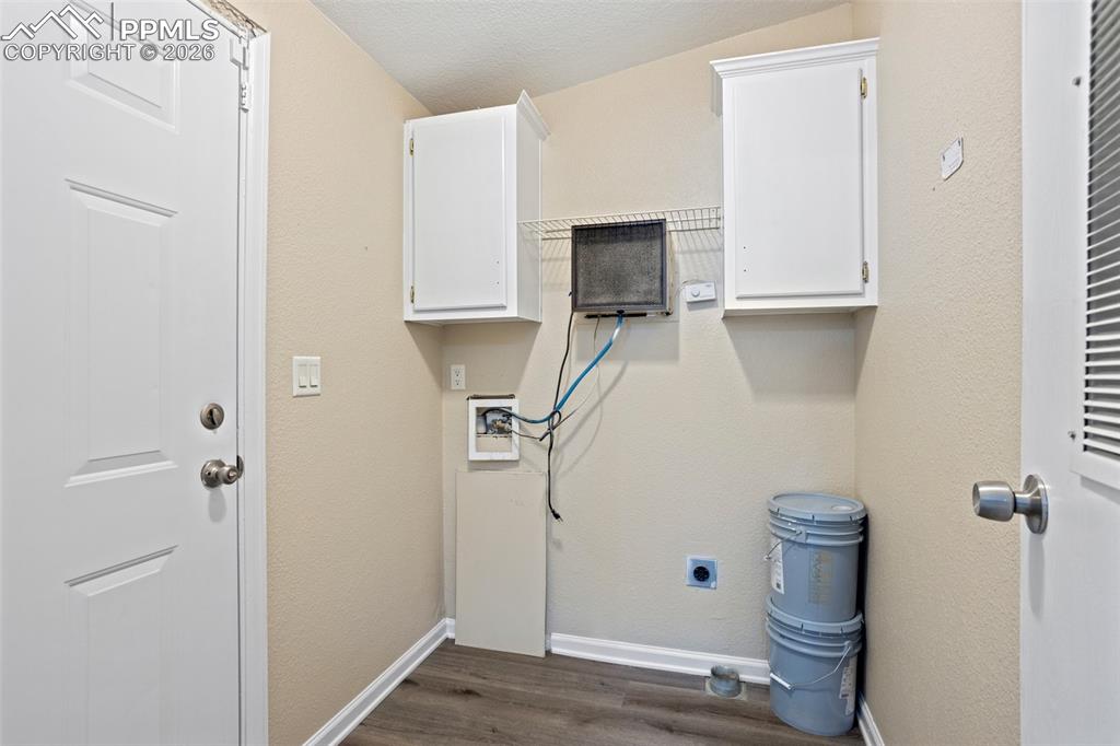Image 19 of 37: The luxury plank flooring continues into the laundry room