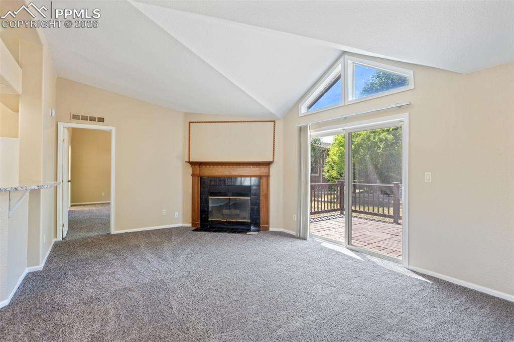 Image 9 of 37: The spacious Living Room features a fireplace to cozy up by!