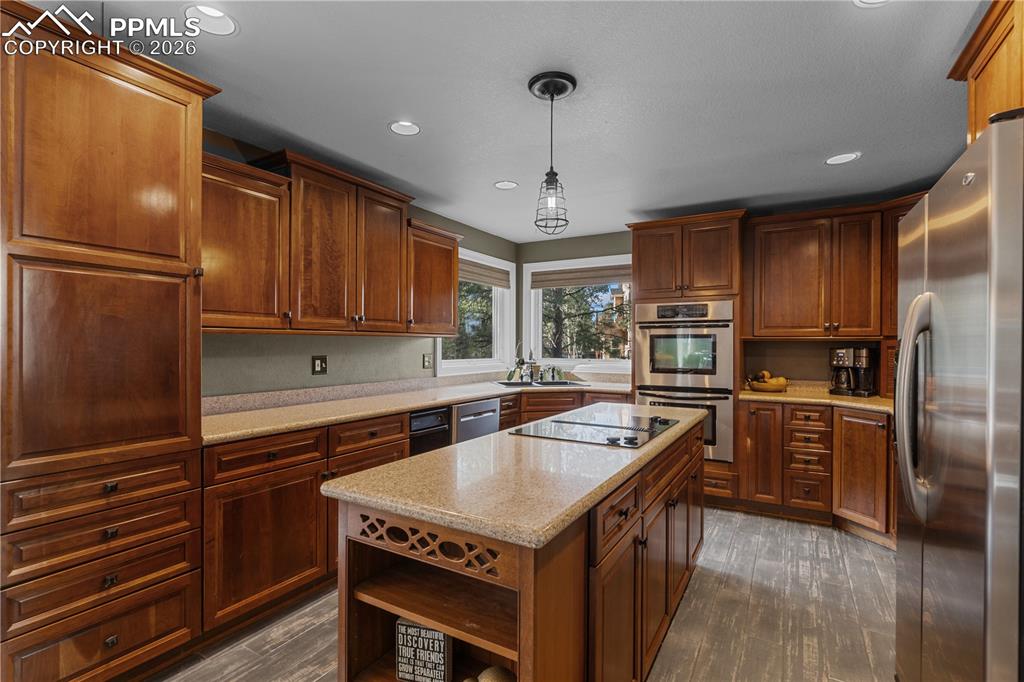 Image 13 of 38: The kitchen has custom cabinetry, Jenn Air Stainless Appliances, and solid 