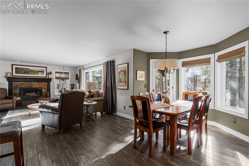 Image 14 of 38: Family room with big bright windows and a gas fireplace, you will want to r