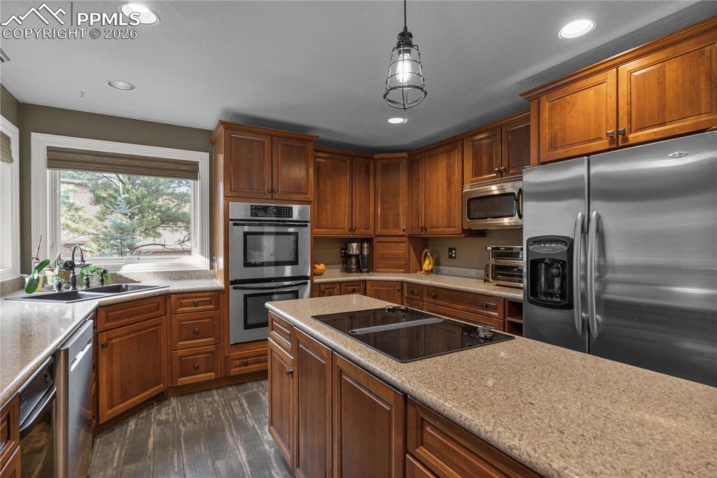 Image 16 of 38: The kitchen has a Jenn Air range top, double ovens, and plenty of storage s