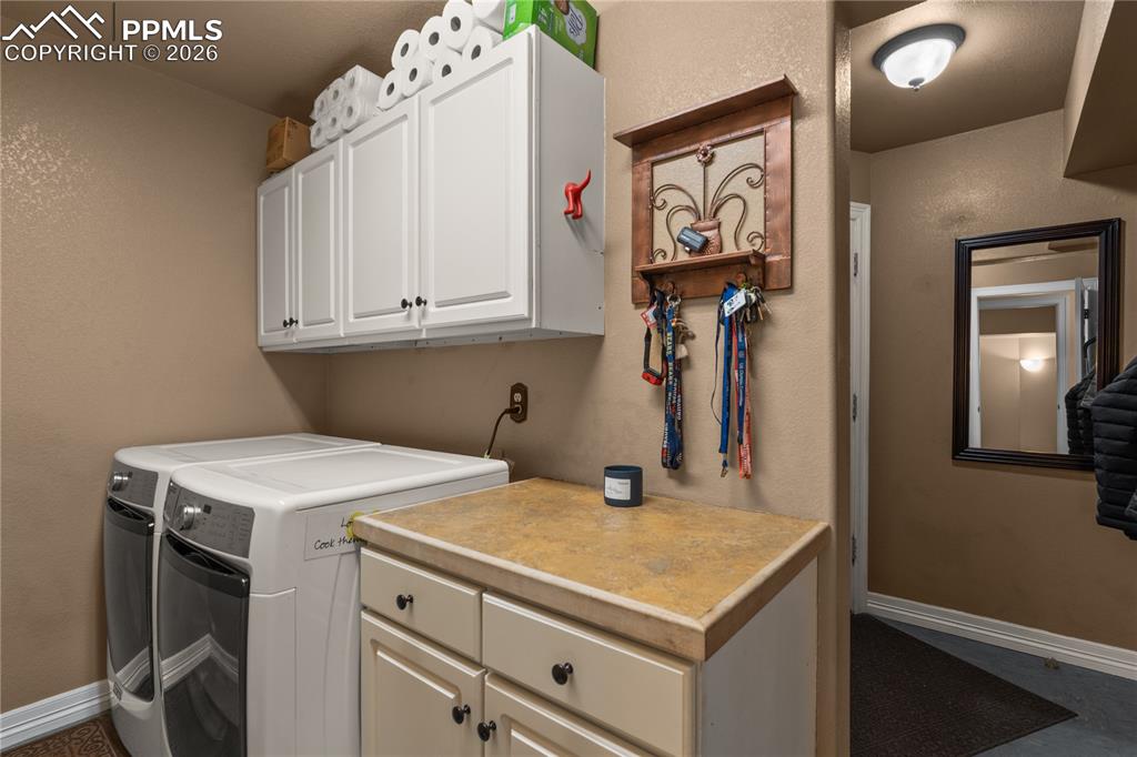 Image 21 of 38: Main level laundry is a convenient drop zone from the garage.