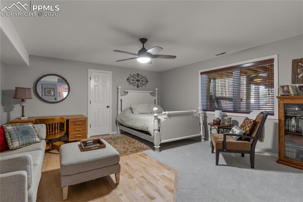Image 35 of 38: Additional spacious basement bedroom with ceiling fan.