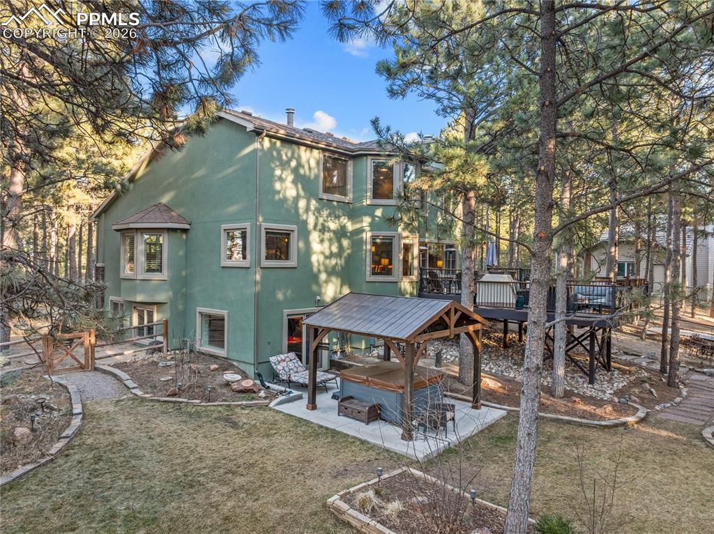 Image 4 of 38: The setting here is magical.  On over 1/2 acre of private pines, there is s