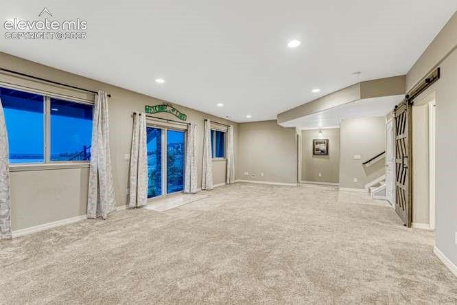 Image 26 of 50: Spacious walk out to covered patio & lake