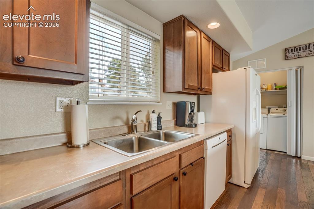 Image 15 of 50: Kitchen featuring wood-finish cabinetry, a double basin stainless steel sin