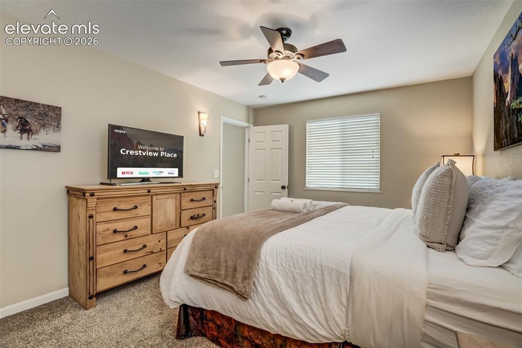 Image 27 of 50: Light-colored walls, ceiling fan with light fixture, window with blinds, wa