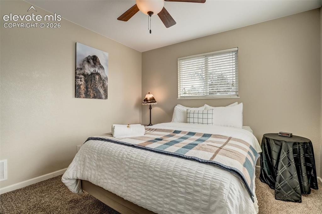 Image 31 of 50: Recessed window with horizontal blinds, overhead ceiling fan with light, an