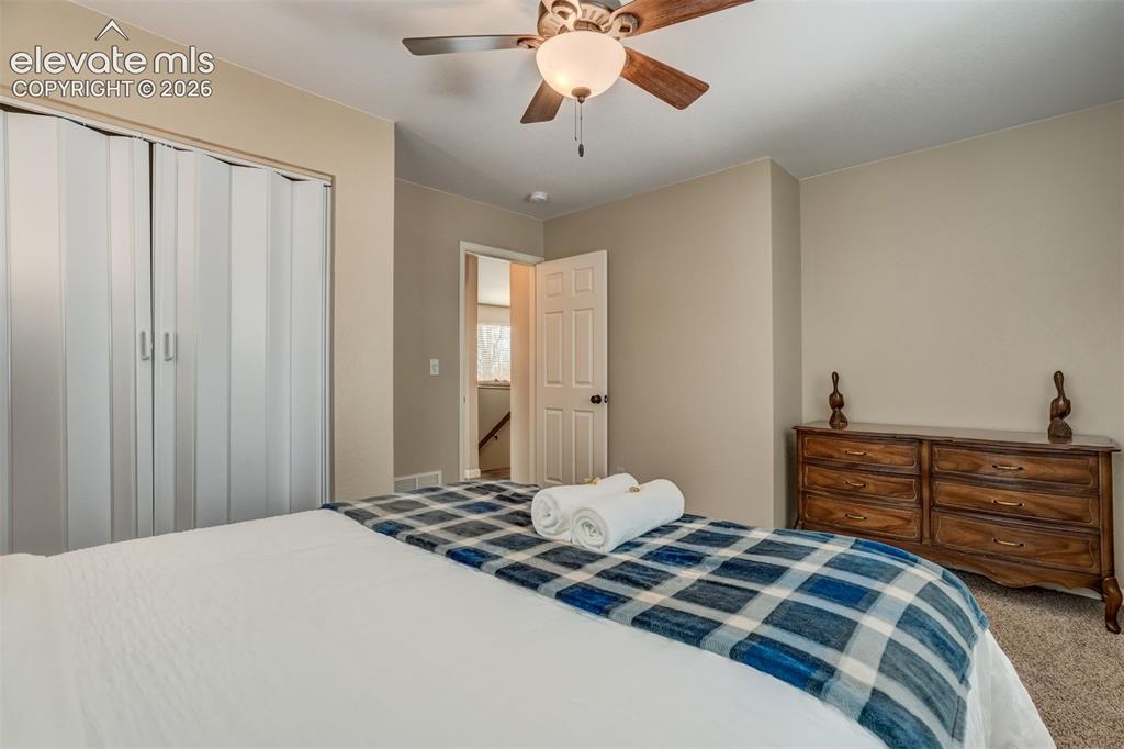 Image 36 of 50: Neutral wall paint, ceiling fan with light fixture, carpeted flooring, and 