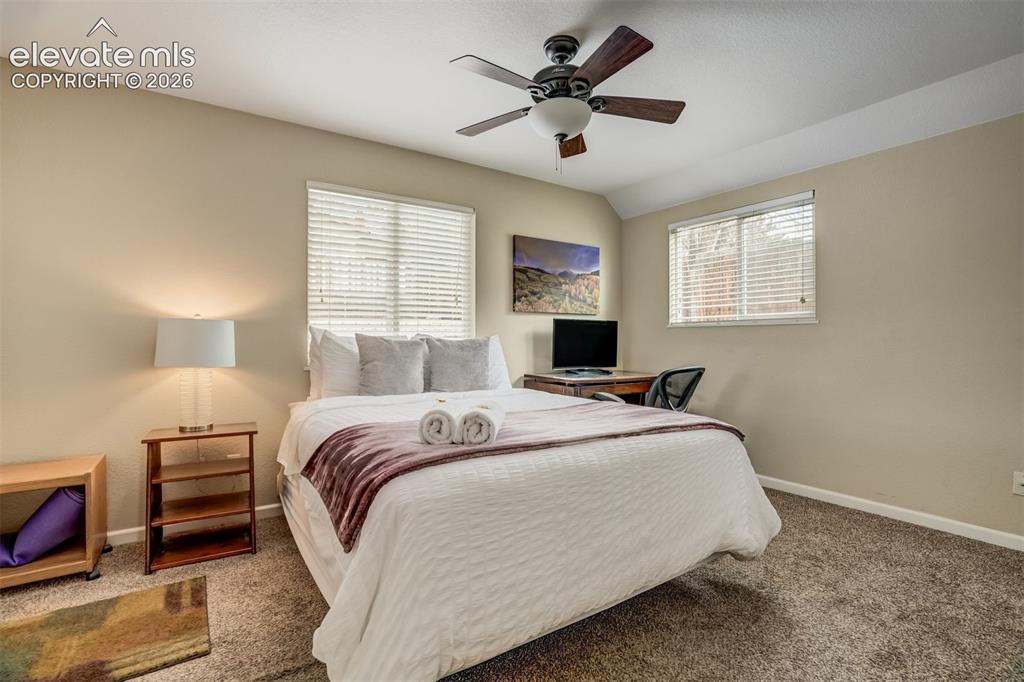 Image 39 of 50: Neutral tone wall paint, carpet flooring, a ceiling fan with integrated lig