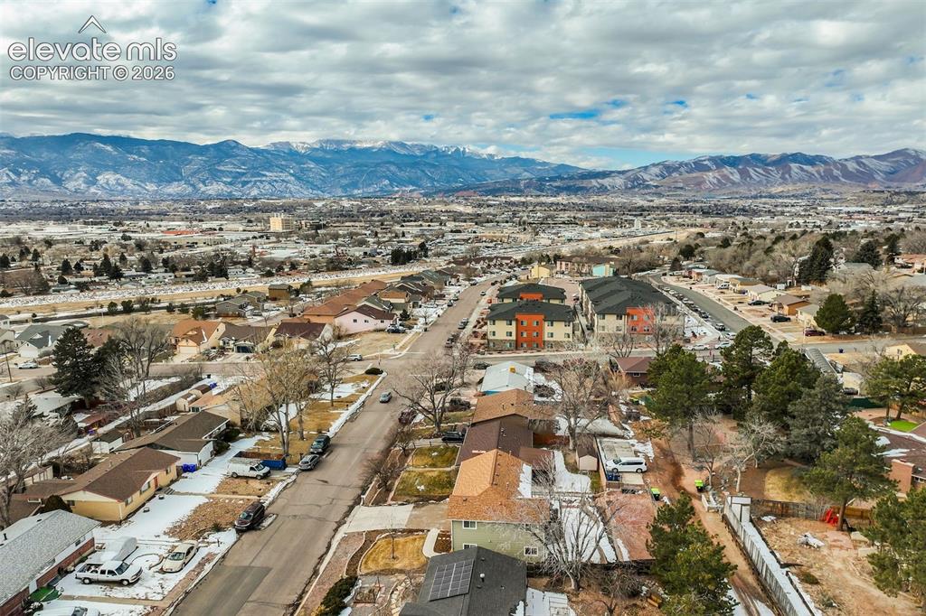 Image 4 of 50: Residential neighborhood with mixed housing types and distant mountainous t