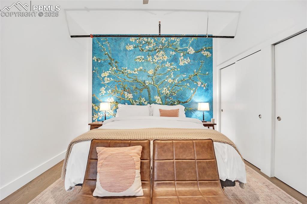 Image 12 of 48: Bedroom featuring baseboards and wood finished floors