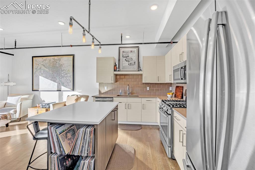 Image 20 of 48: Kitchen with stainless steel appliances, light countertops, a sink, a kitch